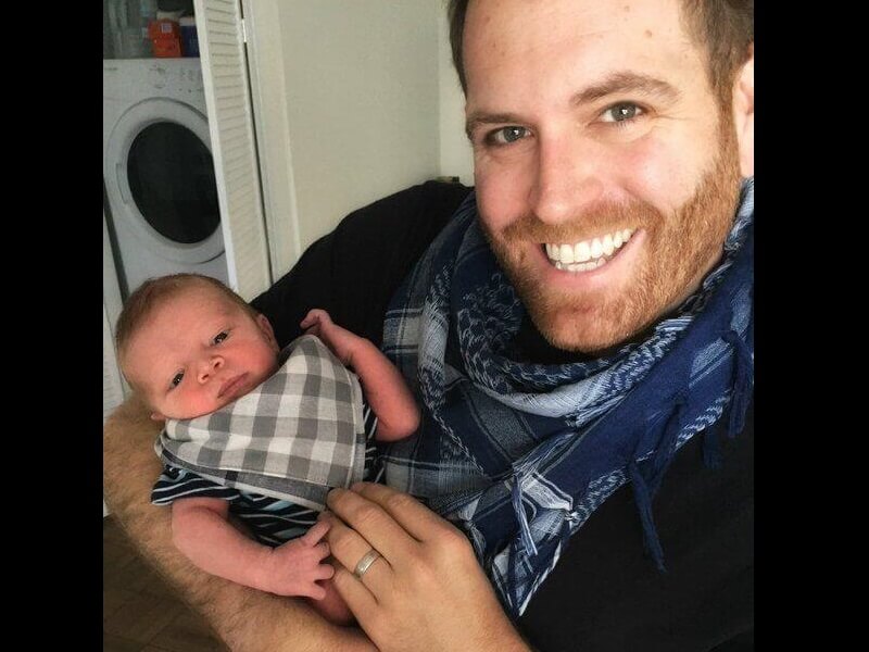 Image of Josh Gates with his baby daughter