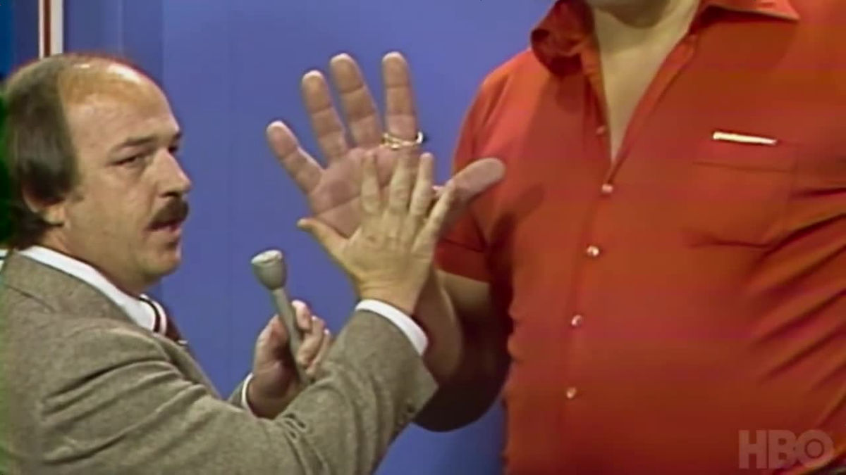 Image of André The Giant's hand compare to regualr sized hand